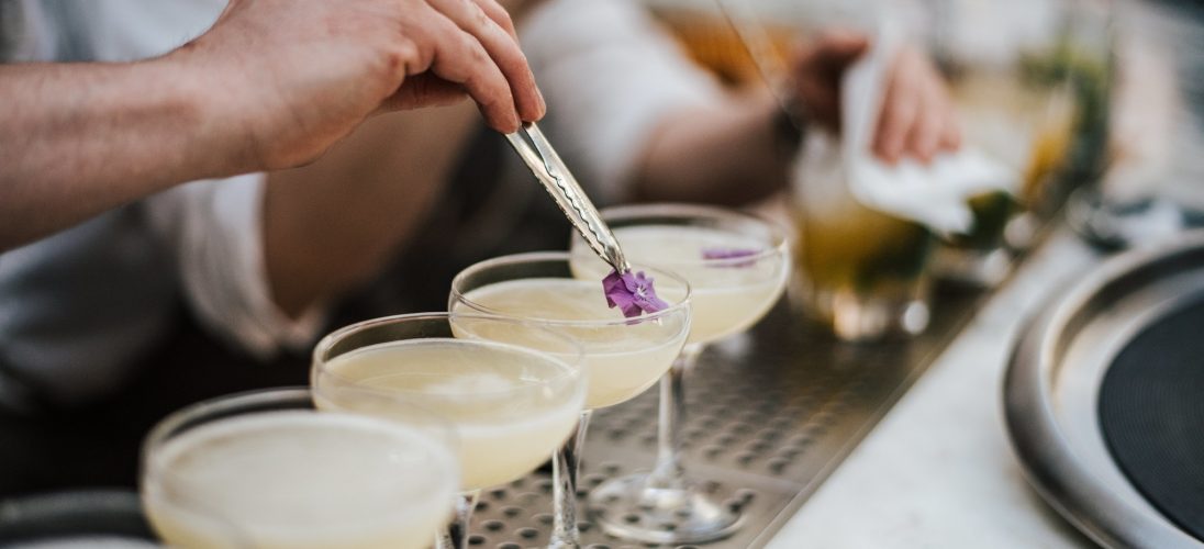 closeup-of-a-barman-making-margaritas-with-five-glasses-set-in-line