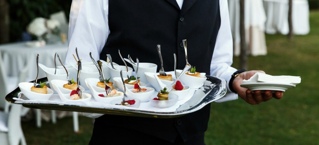 waiter-carries-plate-with-tasty-snacks
